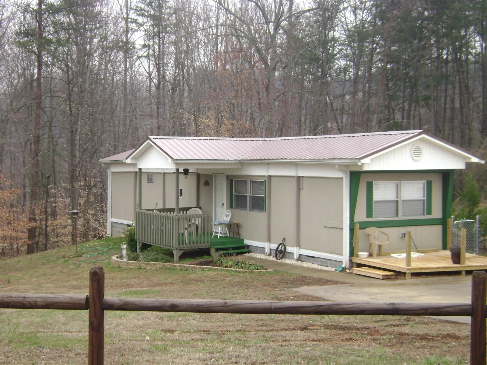 Mauve metal roof on a manufactured home with a new front deck in Guntown